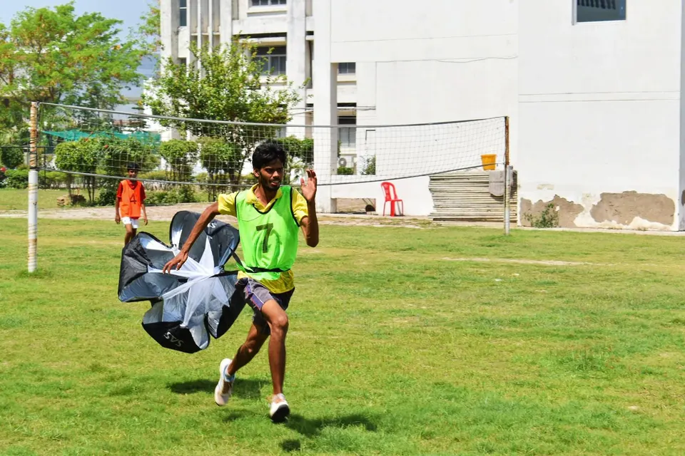 Player sprinting with a resistance parachute during a fitness drill